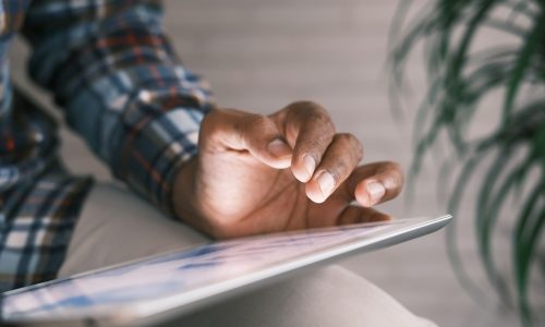 person in blue white and red plaid long sleeve shirt reading book